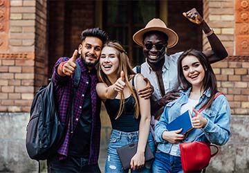 four happy students near university campus