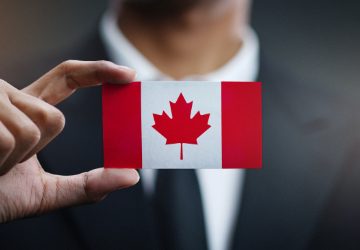 A person holding Canadian flag new immigrant